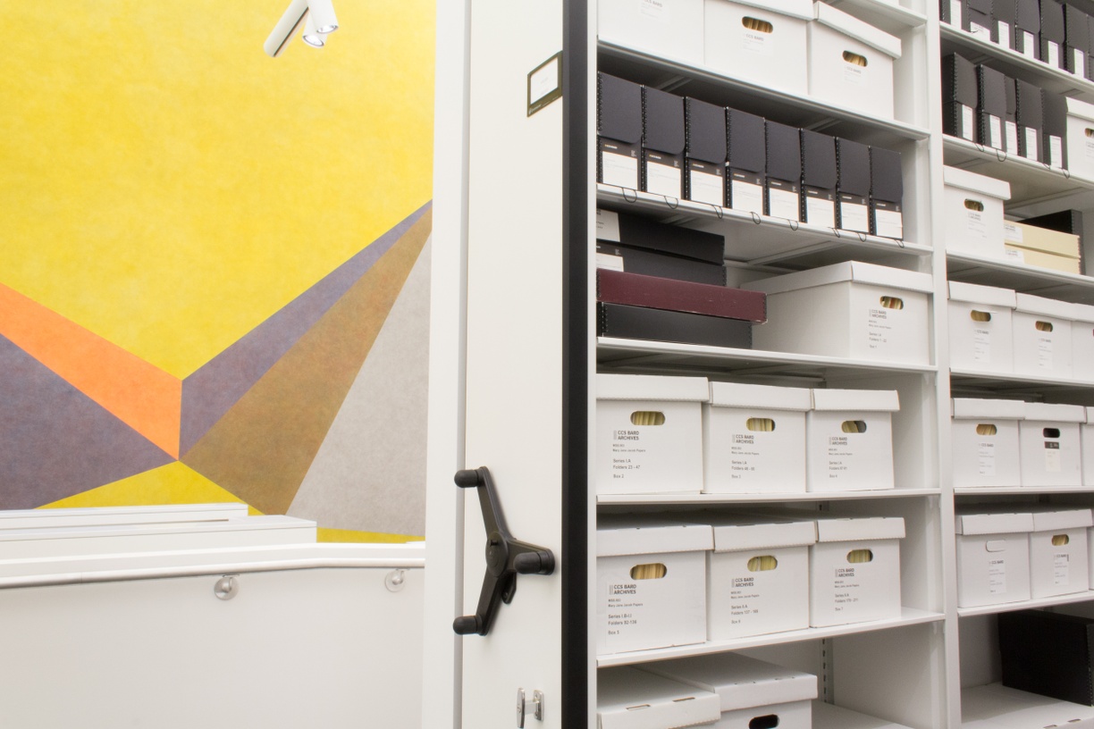 Archives stacks with LeWitt work in background